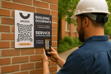 Construction worker scanning Arc Site QR code on building occupants service notice mounted on brick wall